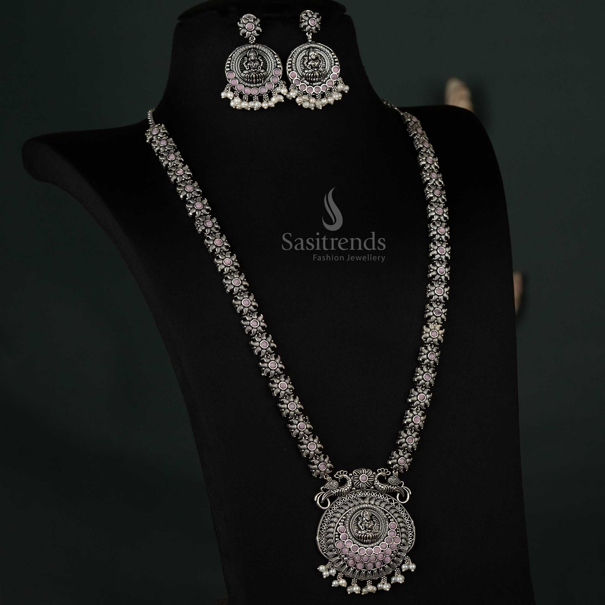 Elegant oxidized necklace with peacock and Lakshmi pendants and pearl drops in pink, offering a graceful and feminine ethnic look - Sasitrends