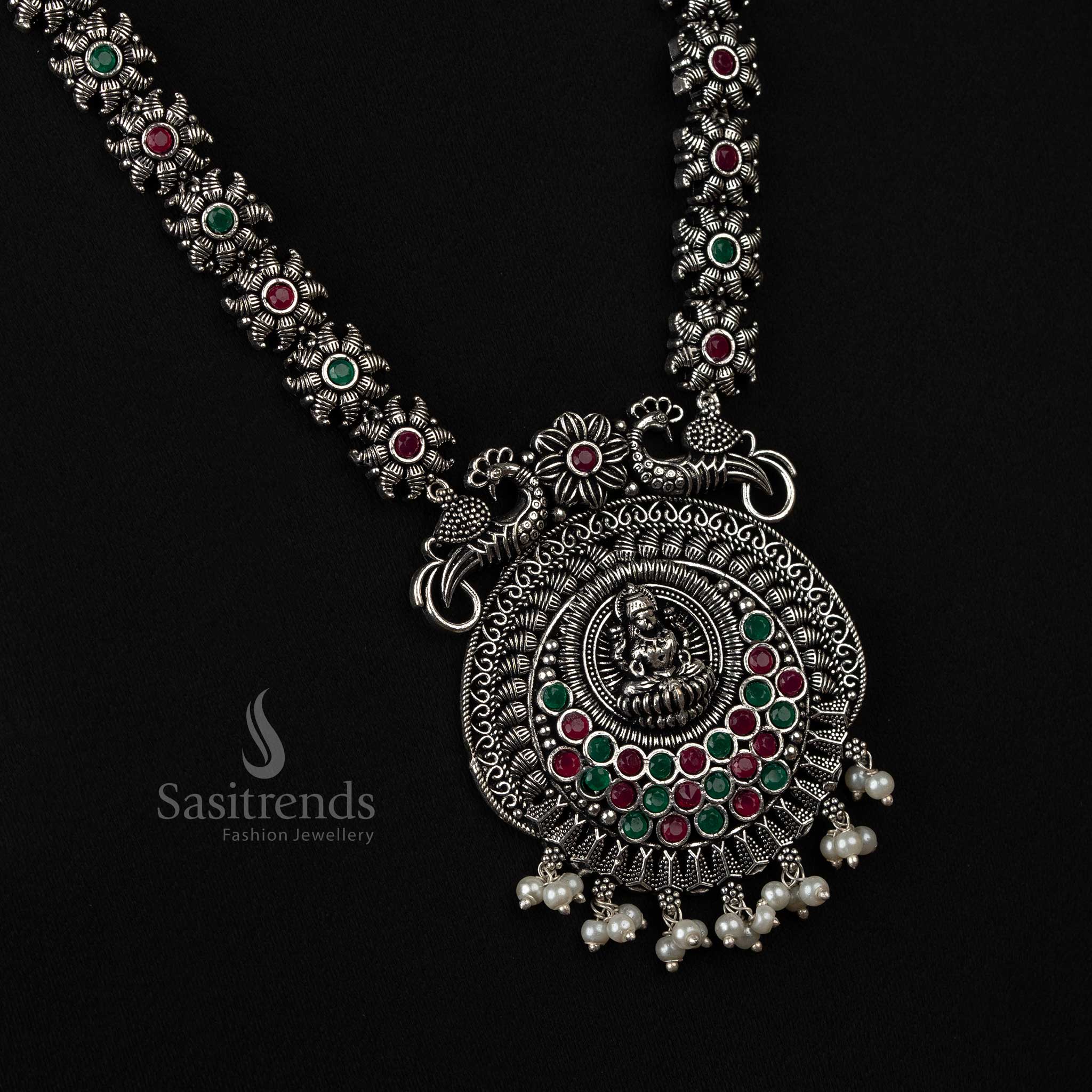 Delicate oxidized necklace featuring peacock and Lakshmi motifs with pearl drops in soft ruby-green, adding a refreshing touch to any outfit - Sasitrends