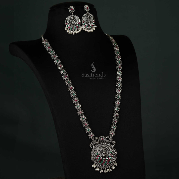 Beautiful oxidized peacock and Lakshmi pendant necklace set with pearl drops in ruby and green tones, ideal for weddings and cultural events - Sasitrends