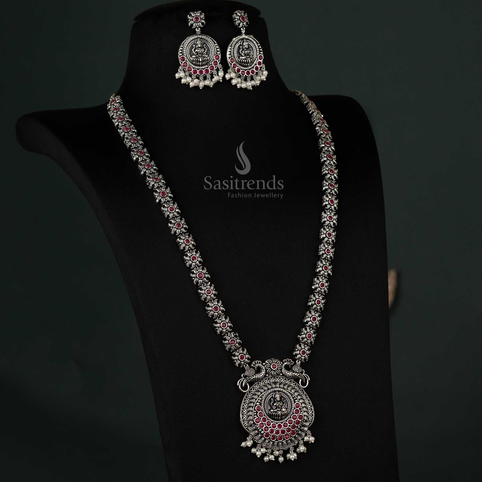 Exquisite oxidized necklace featuring a peacock and Lakshmi pendant with pearl drops in rich ruby, designed for timeless ethnic elegance - Sasitrends