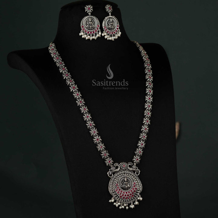 Exquisite oxidized necklace featuring a peacock and Lakshmi pendant with pearl drops in rich ruby, designed for timeless ethnic elegance - Sasitrends