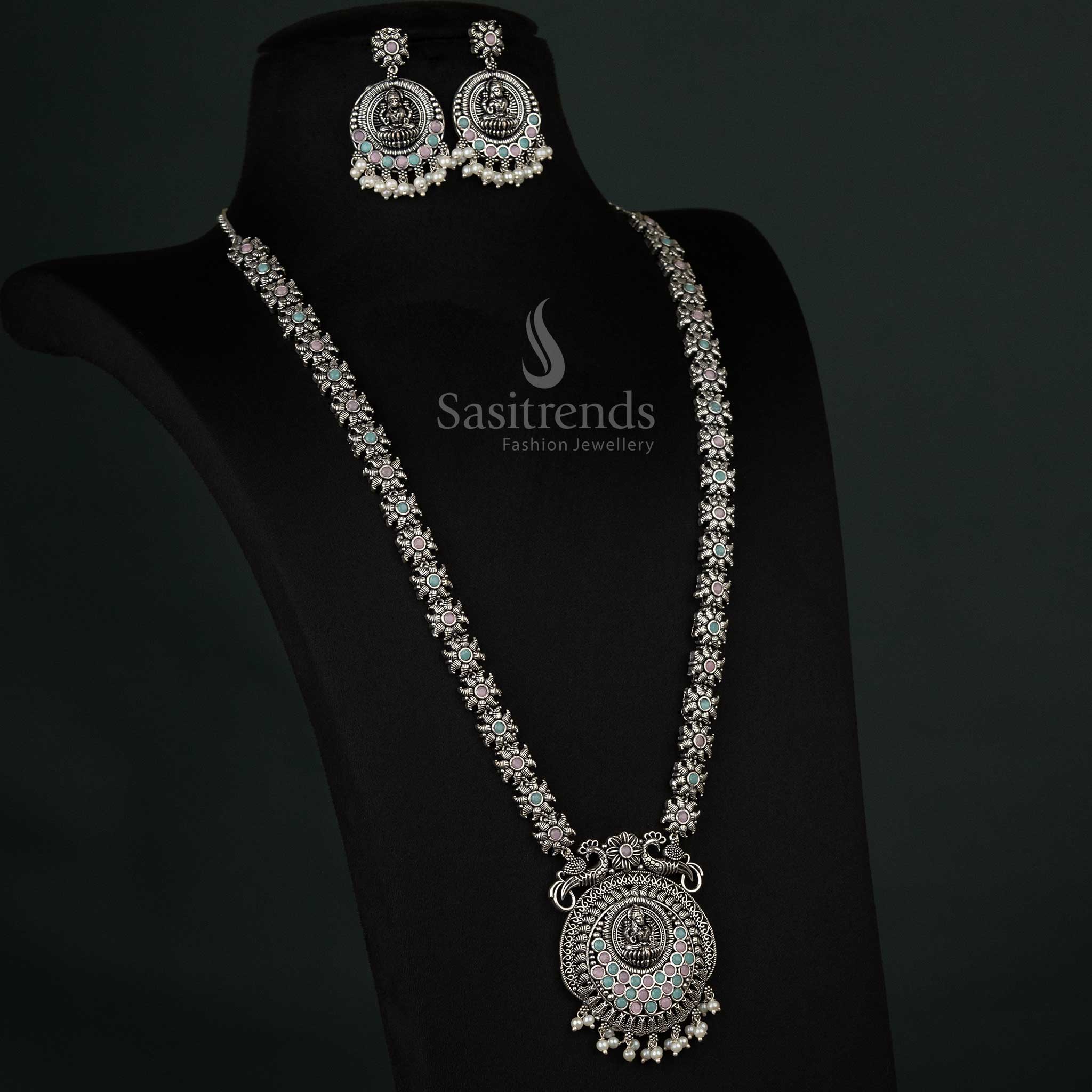 Charming oxidized necklace set with peacock and Lakshmi motifs and pearl drops in pink and mint, ideal for artistic and vibrant styling - Sasitrends