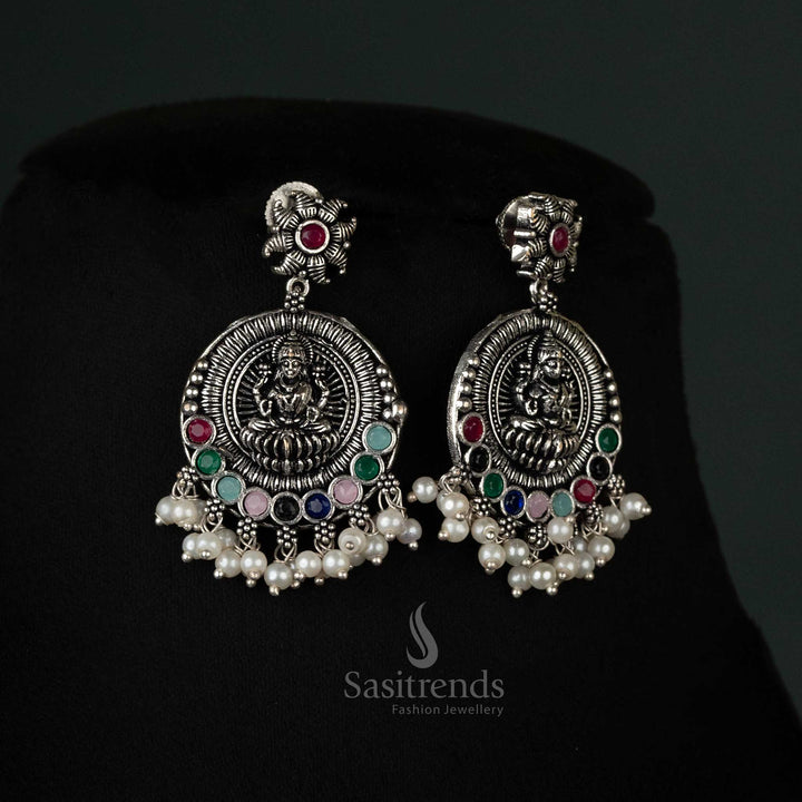 Stylishly crafted oxidized earrings with peacock and Lakshmi motifs and pearl drops in vibrant multi color, perfect for festive celebrations - Sasitrends