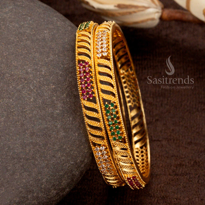 Beautiful micro gold-plated bangles featuring an intricate leaf pattern, studded with vibrant multi-color American diamond stones - Sasitrends