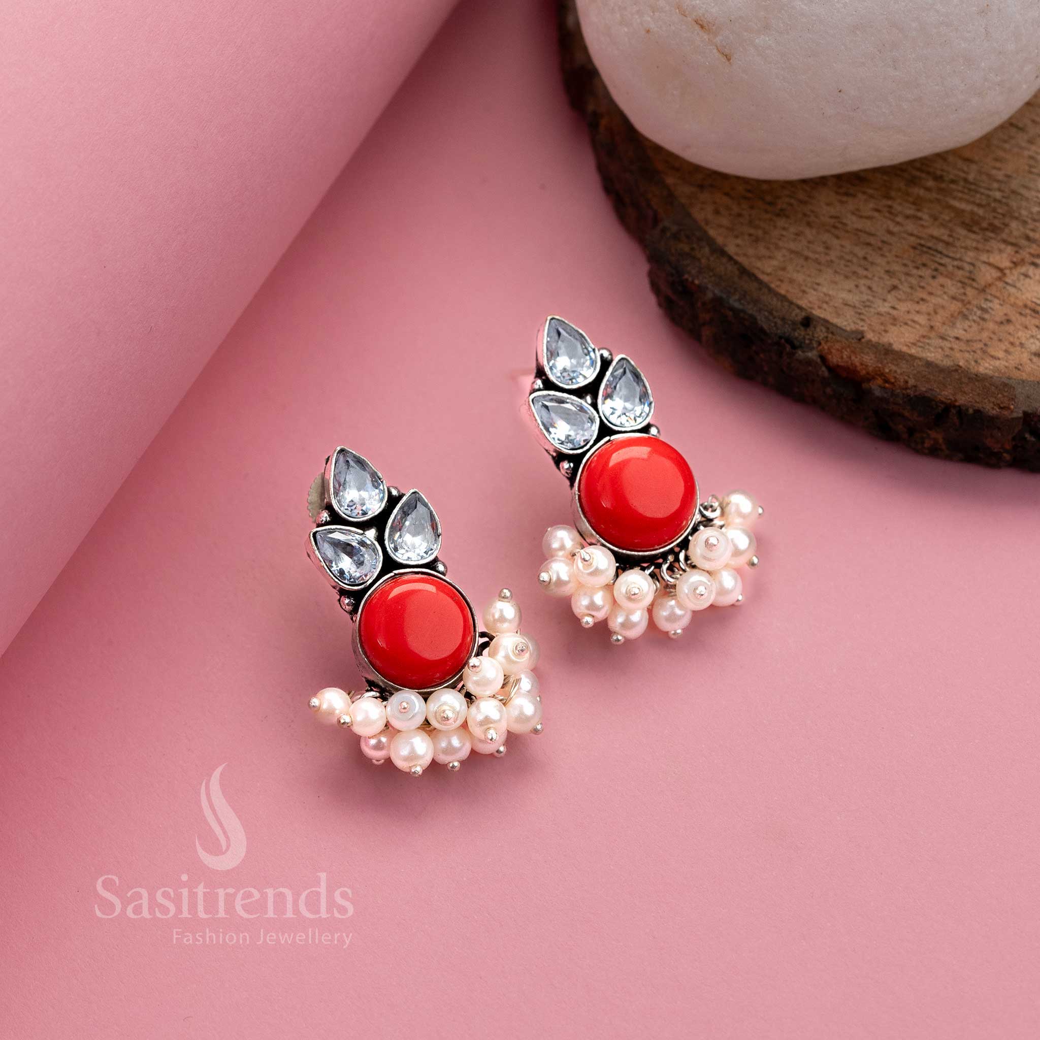 Fiery red oxidised German silver earrings with bright Monalisa centre, AD stones and pearl details – traditional elegance by Sasitrends