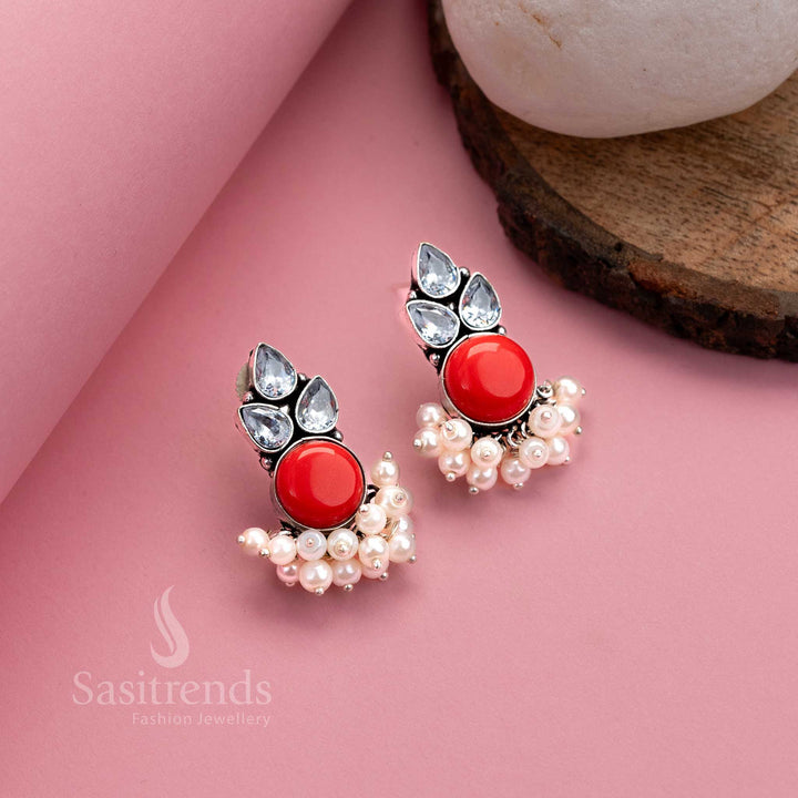 Fiery red oxidised German silver earrings with bright Monalisa centre, AD stones and pearl details – traditional elegance by Sasitrends