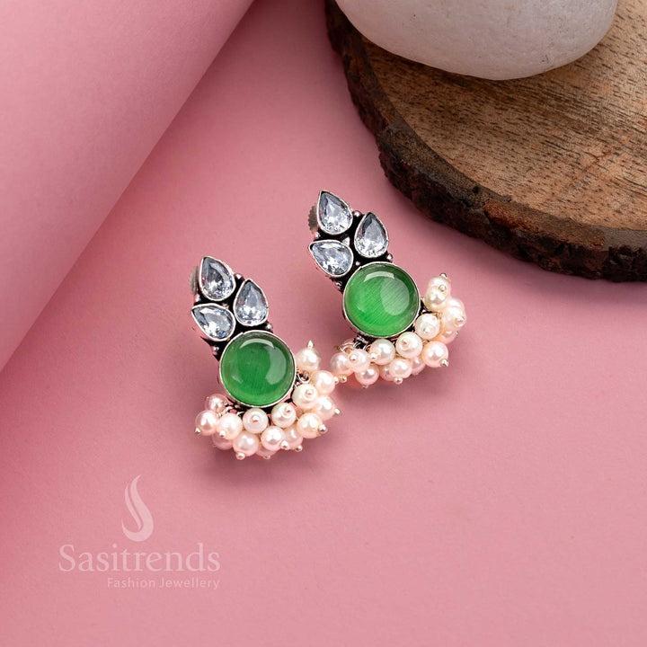 Light green oxidised German silver earrings with luminous Monalisa stone, AD sparkle and elegant pearl layers – subtle festive jewellery from Sasitrends