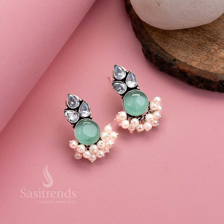 Cool mint oxidised silver earrings featuring lustrous Monalisa gemstone, AD work and pearl hangings – traditional elegance by Sasitrends