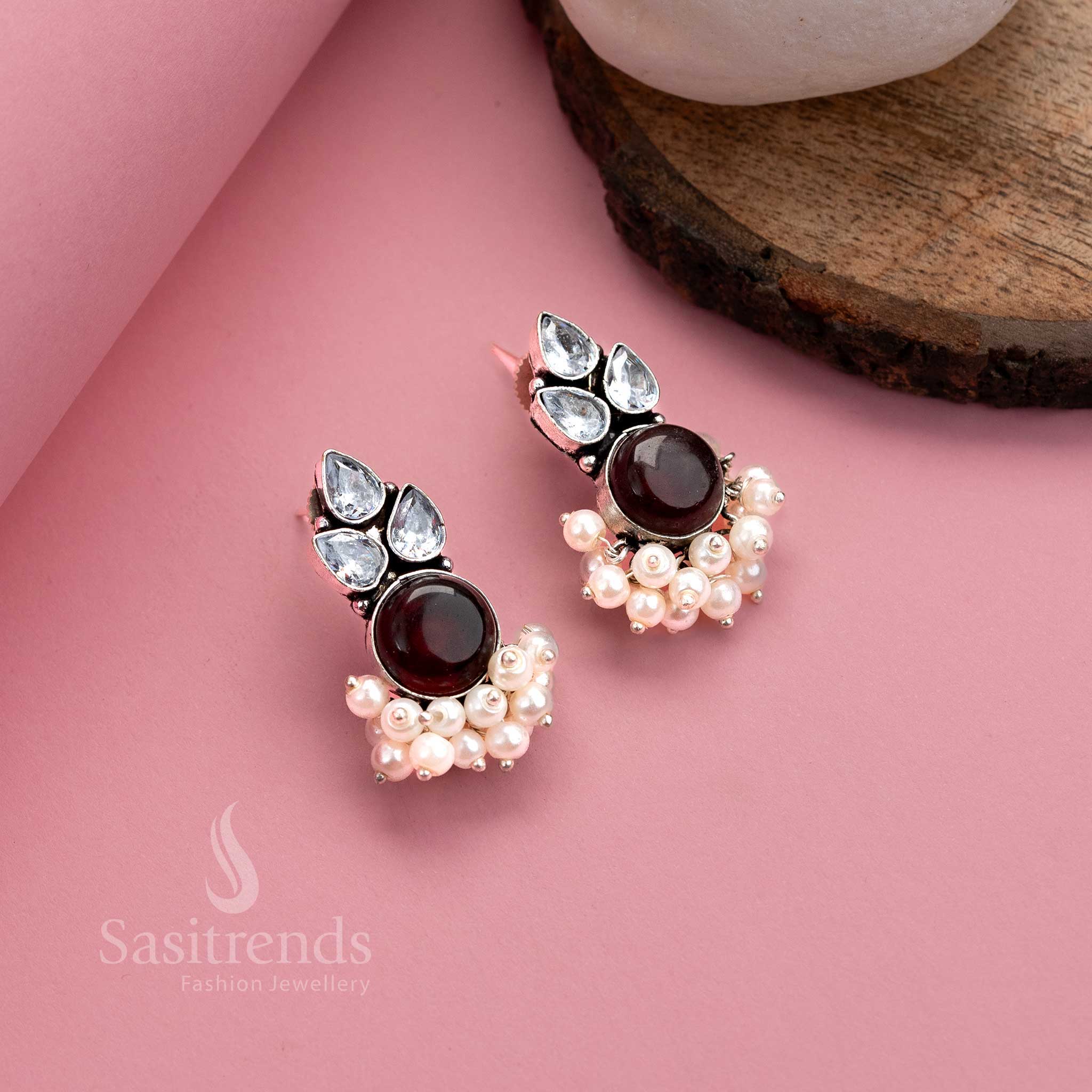 Elegant vinous oxidised German silver earrings with shimmering Monalisa stone, glittering AD accents and pearl hangings – vintage tone jewellery from Sasitrends