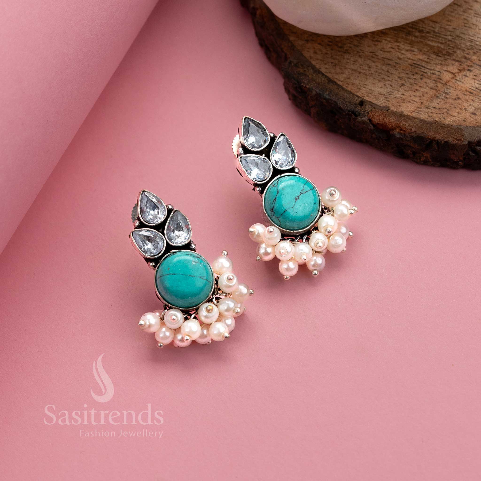 Radiant turquoise oxidised silver earrings with Monalisa gemstone, AD shimmer and soft pearl hangings – eye-catching jewellery by Sasitrends