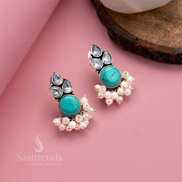 Radiant turquoise oxidised silver earrings with Monalisa gemstone, AD shimmer and soft pearl hangings – eye-catching jewellery by Sasitrends