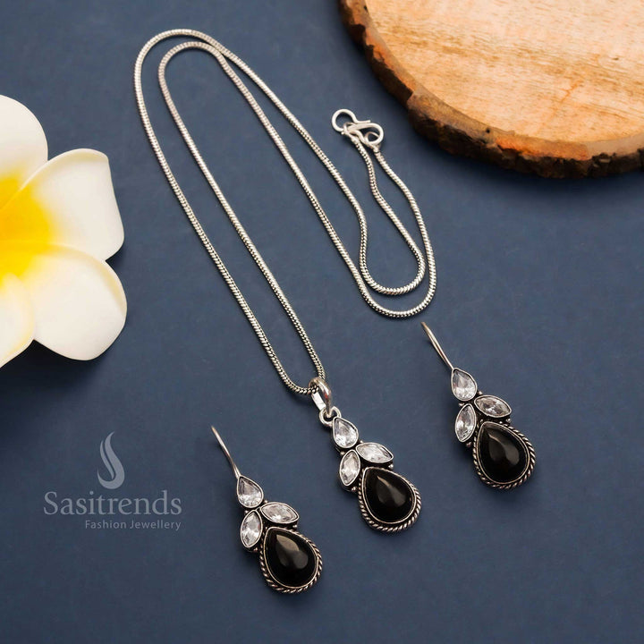 Bold black oxidised floral pendant set with shimmering Monalisa stones and sparkling AD touches – accompanied by matching hook earrings – Sasitrends