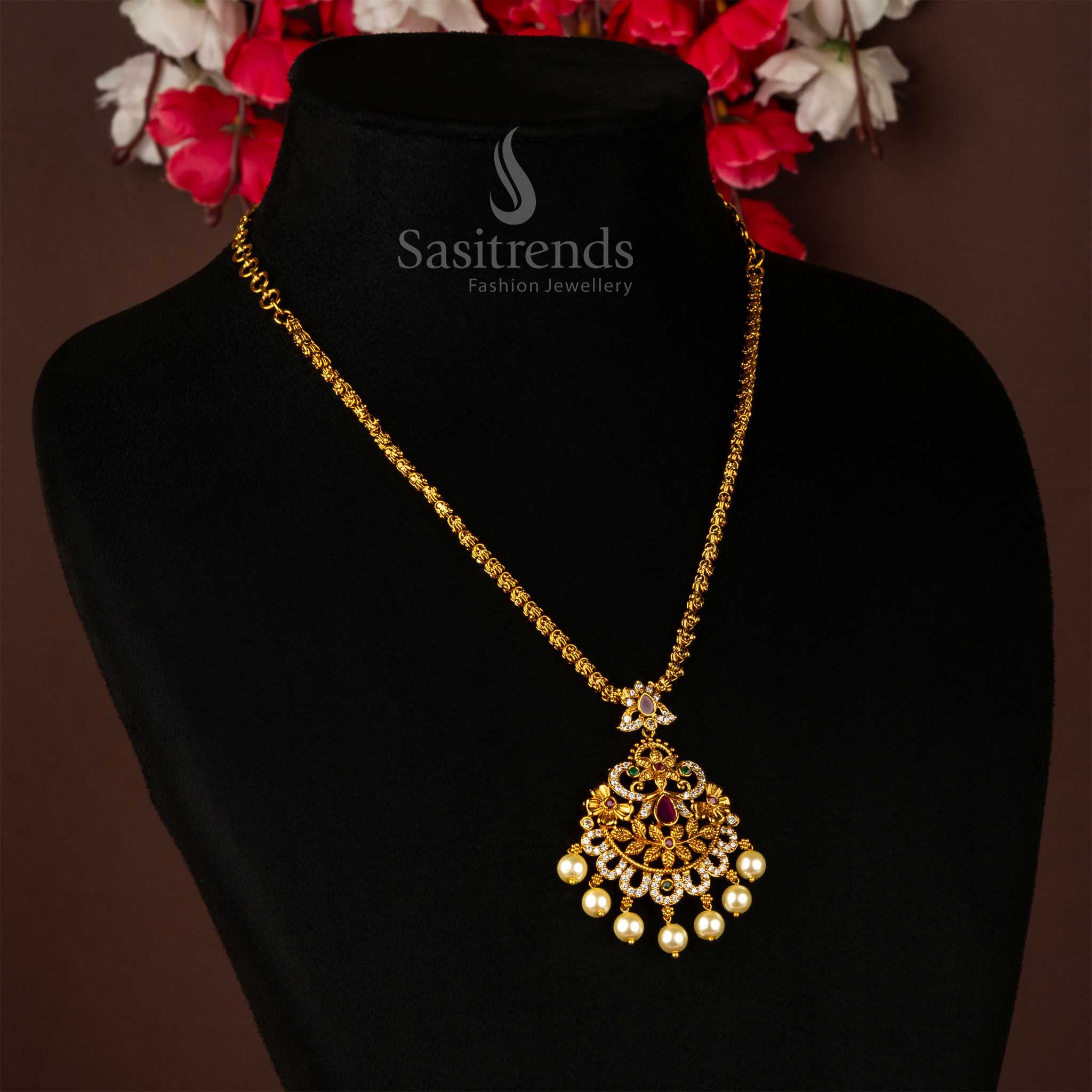 Graceful matte gold floral pendant necklace chain jewellery adorned with radiant AD stone accents and soft pearl embellishments – a radiant blossom-inspired adornment perfect for sarees, weddings, and South Indian cultural charm – Sasitrends