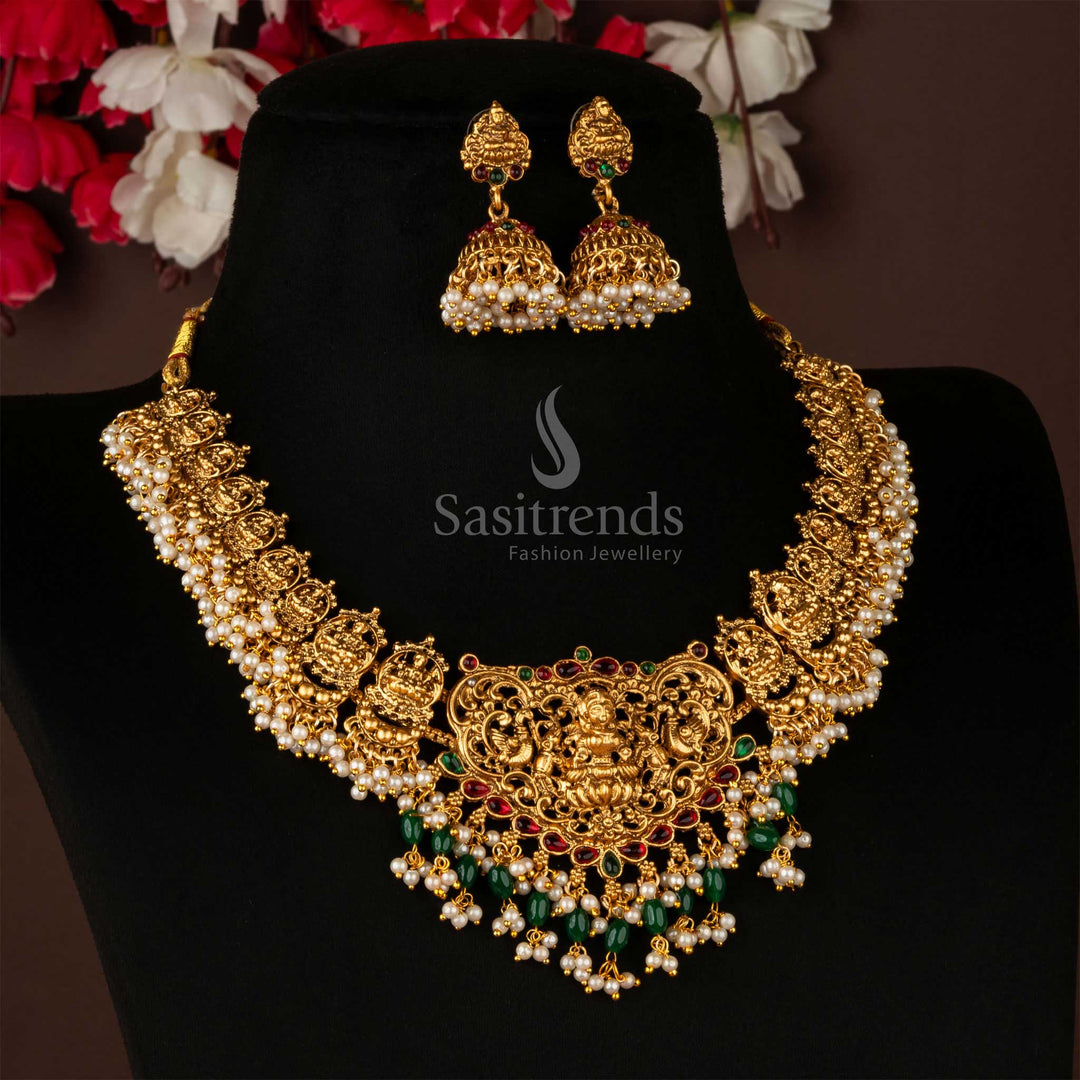 Traditional matte gold necklace set adorned with Lakshmi and peacock pendant motifs, designed with vintage temple charm – a striking ethnic jewellery piece perfect for saree styling and wedding celebrations – Sasitrends
