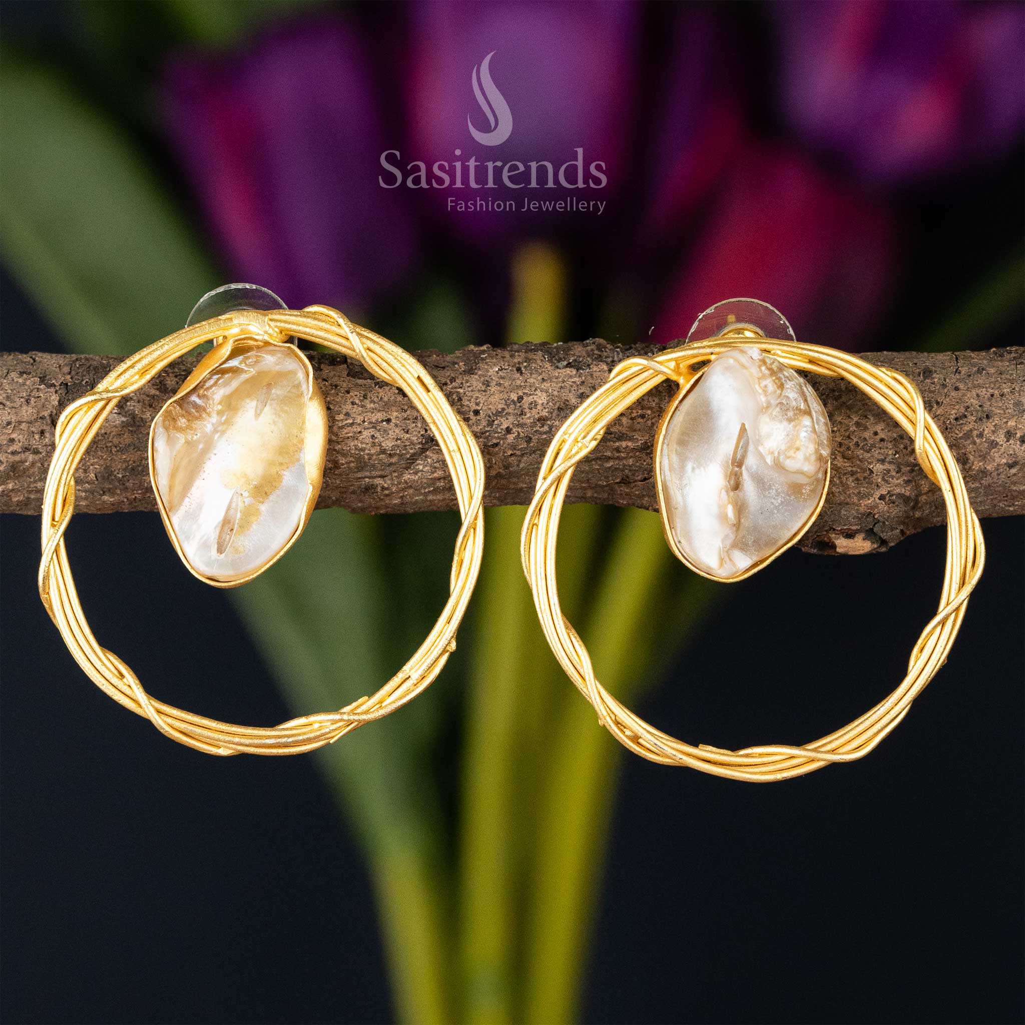 Chic twisted gold hoop earrings with a lustrous Mother of Pearl centerpiece