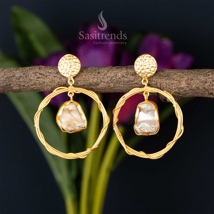 Elegant golden hoops with dangling Mother of Pearl charm for a chic look