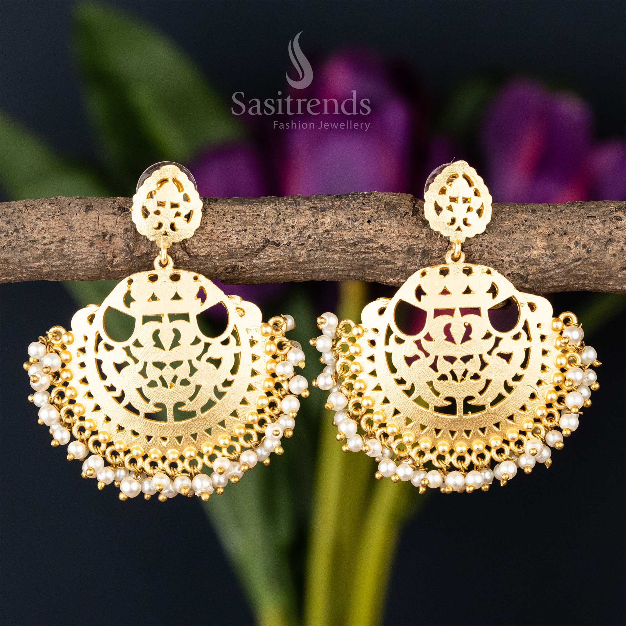 Ornate golden filigree earrings with pearl embellishments, combining traditional craftsmanship with modern design
