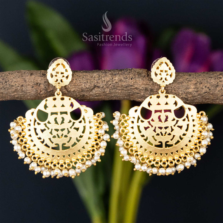 Ornate golden filigree earrings with pearl embellishments, combining traditional craftsmanship with modern design