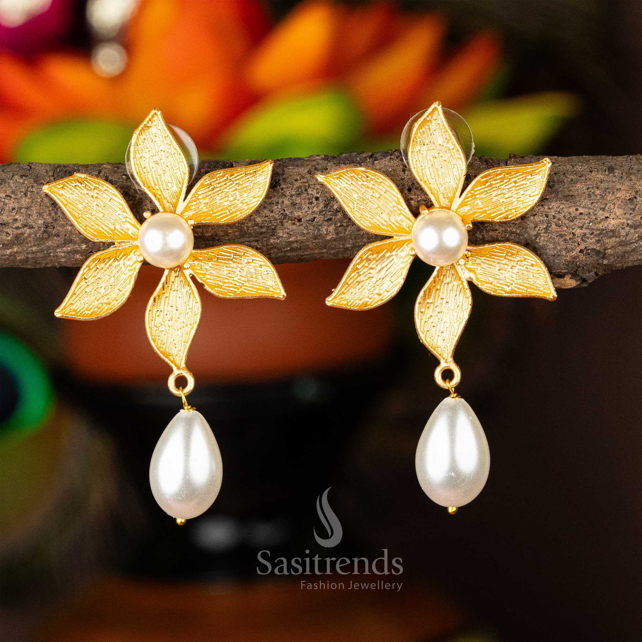 Gold-plated pearl earrings with a floral motif and pearl drop