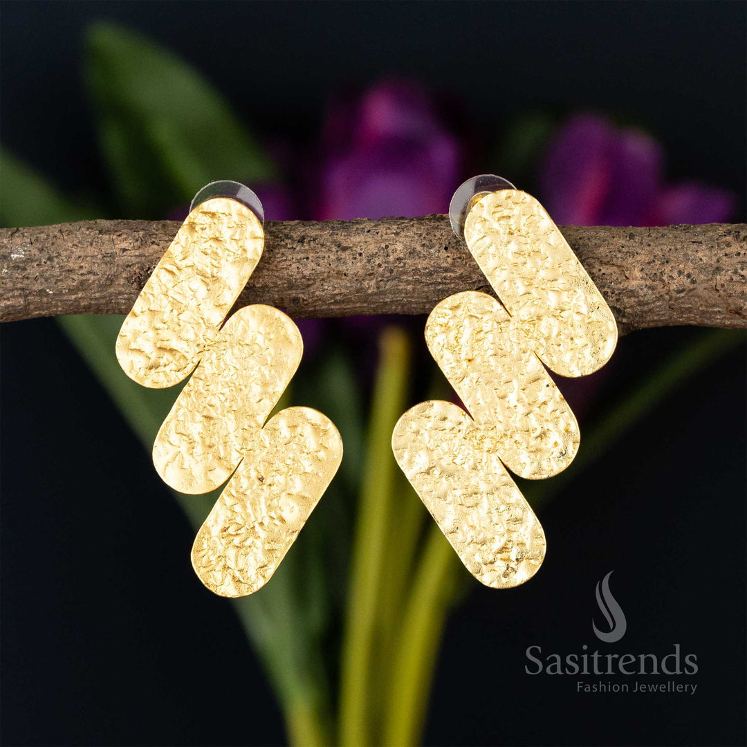 Textured crossbar gold-plated earrings on a natural twig