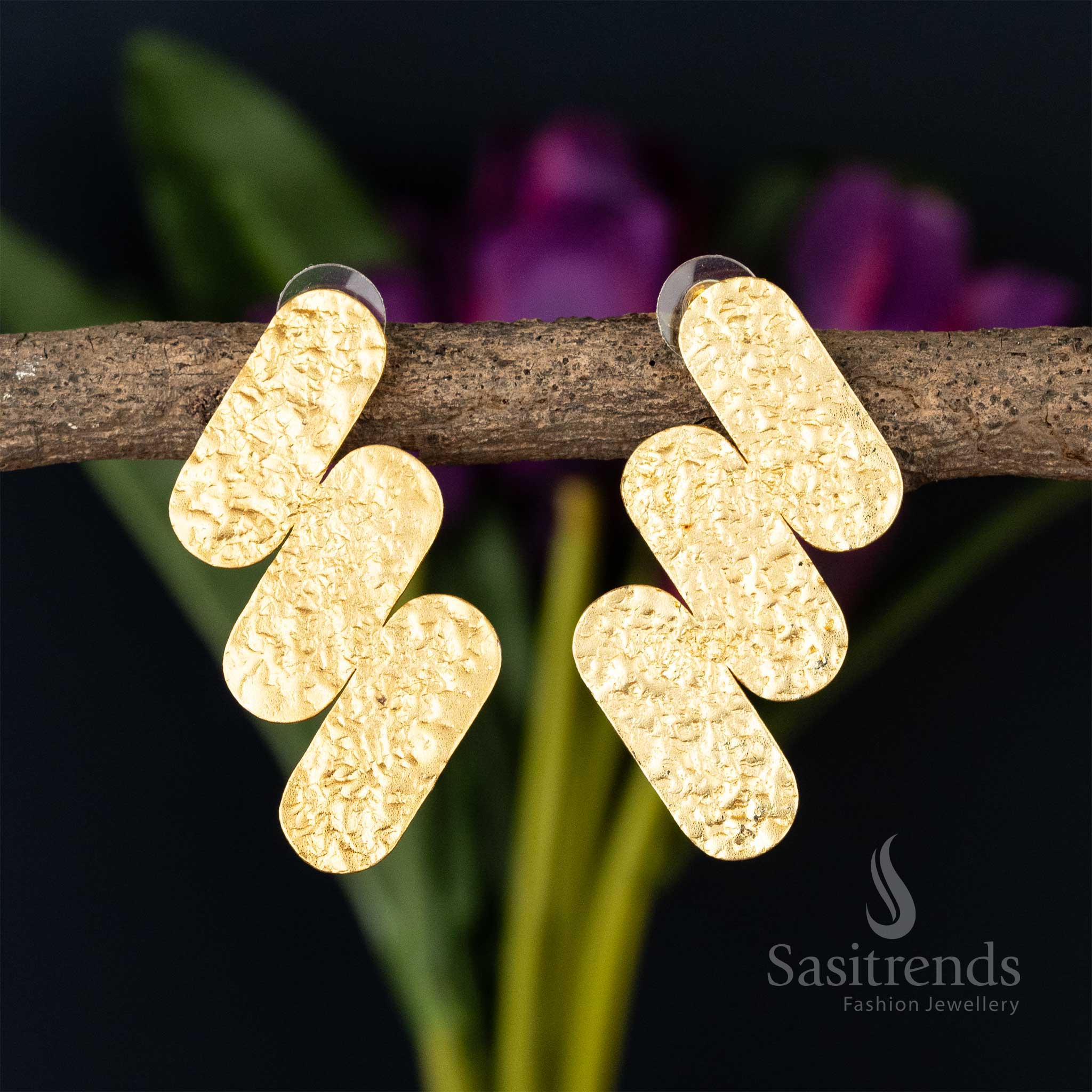 Textured crossbar gold-plated earrings on a natural twig