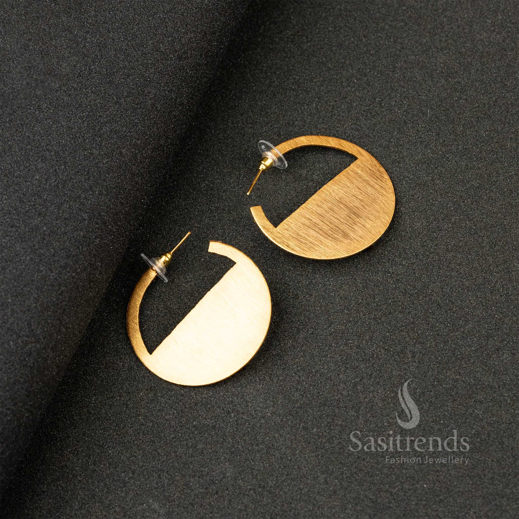 Sleek gold-plated semicircle stud earrings with a satin finish on a black surface