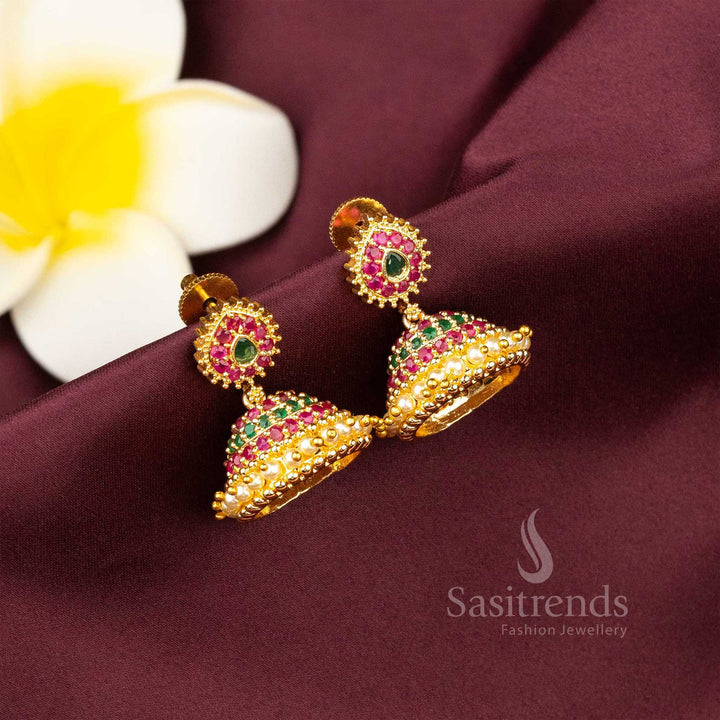 Elegant ruby-green micro gold plated AD jhumka earrings with dual-tone kemp stone motifs and graceful pearl details – timeless festival style – Sasitrends