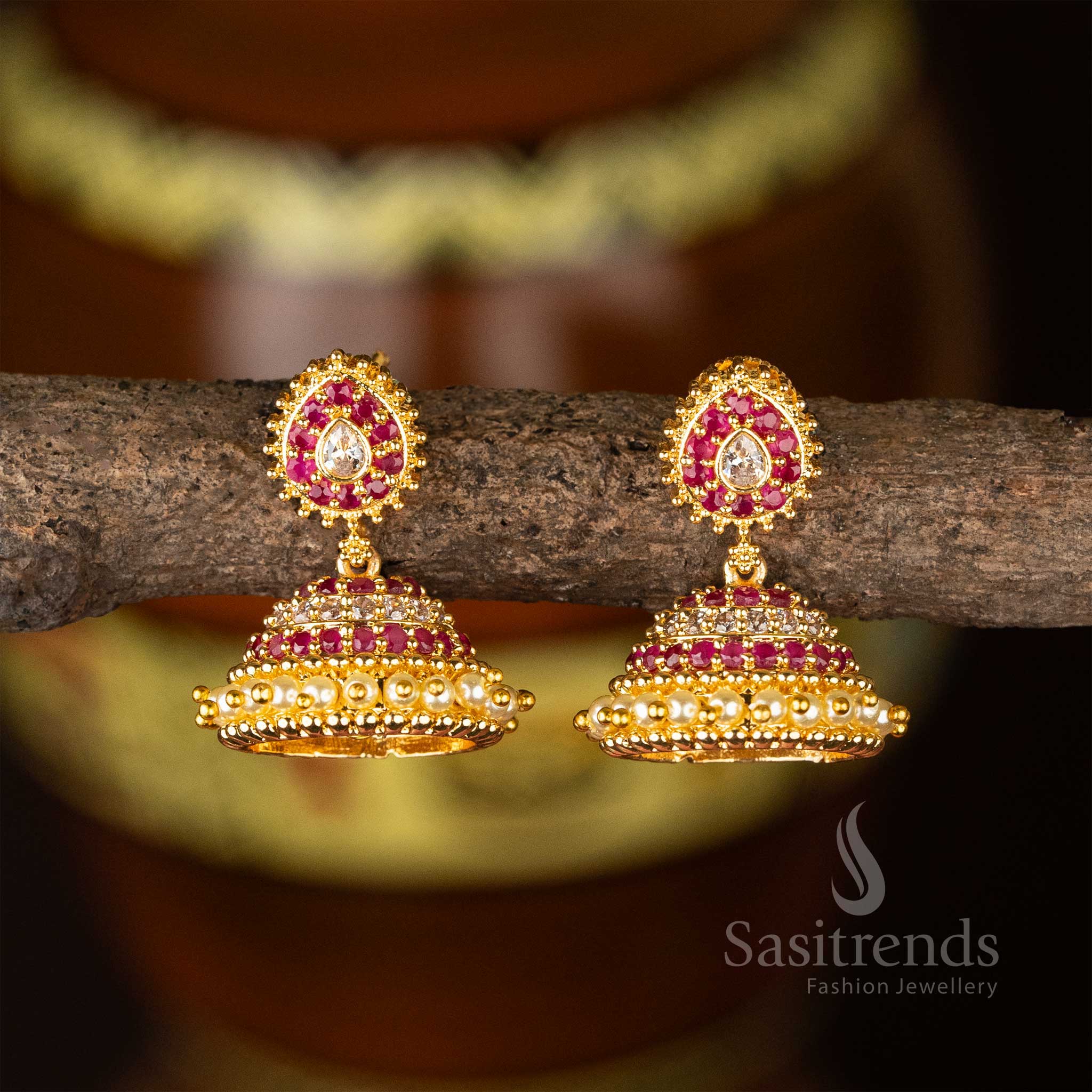 Ornate micro gold plated white-ruby jhumkas with vintage AD stone design and structured pearl drops – perfect for wedding function style – Sasitrends