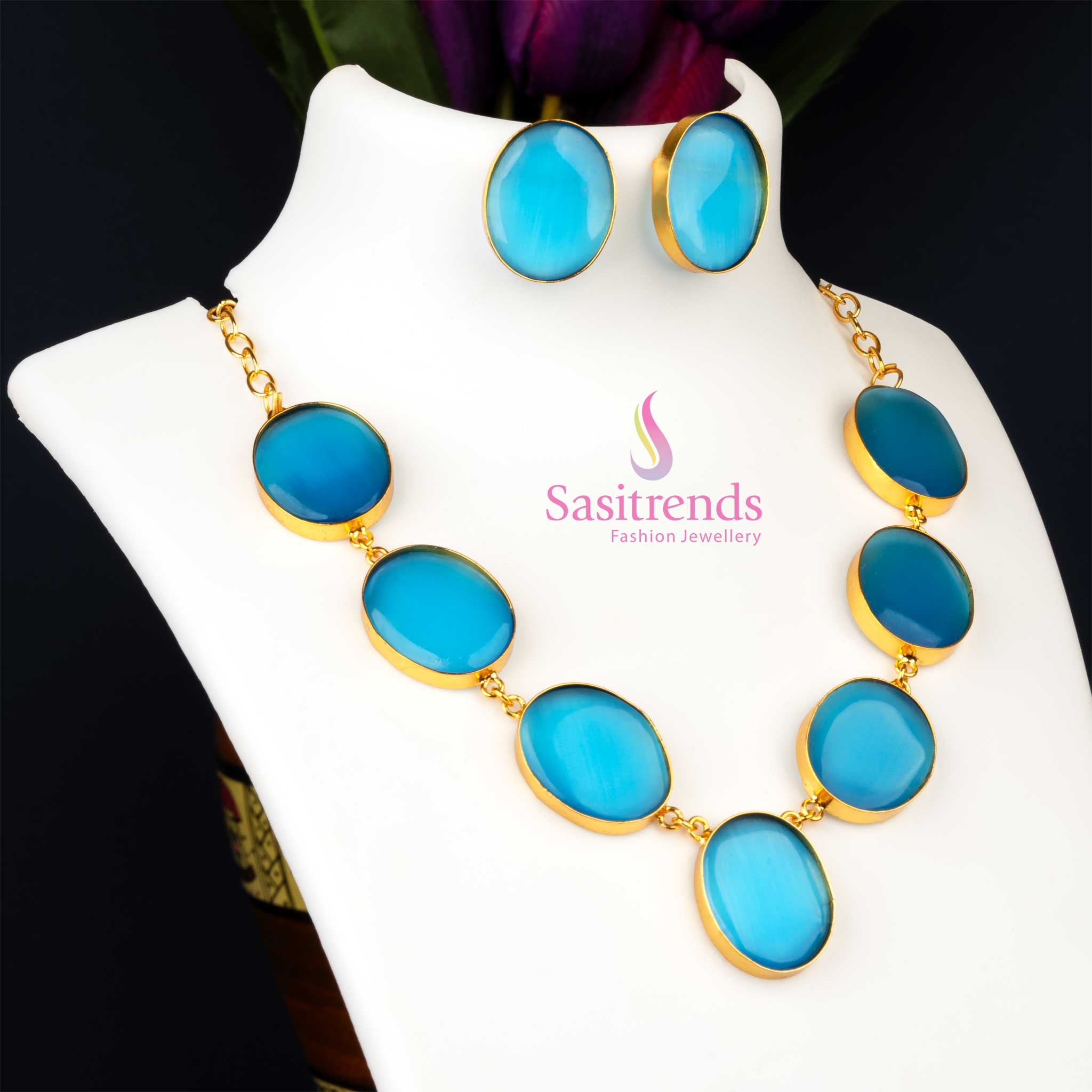 Dazzling gold plated Monalisa stone feather jewellery set in a deep sapphire blue, designed for party wear collections, exuding captivating radiance from Sasitrends