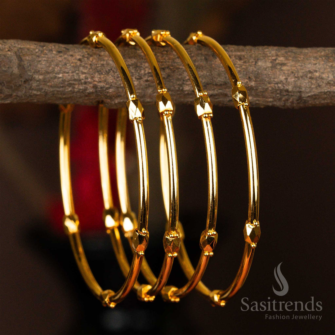 Set of four micro gold-plated kada bangles with elegant faceted golden beads