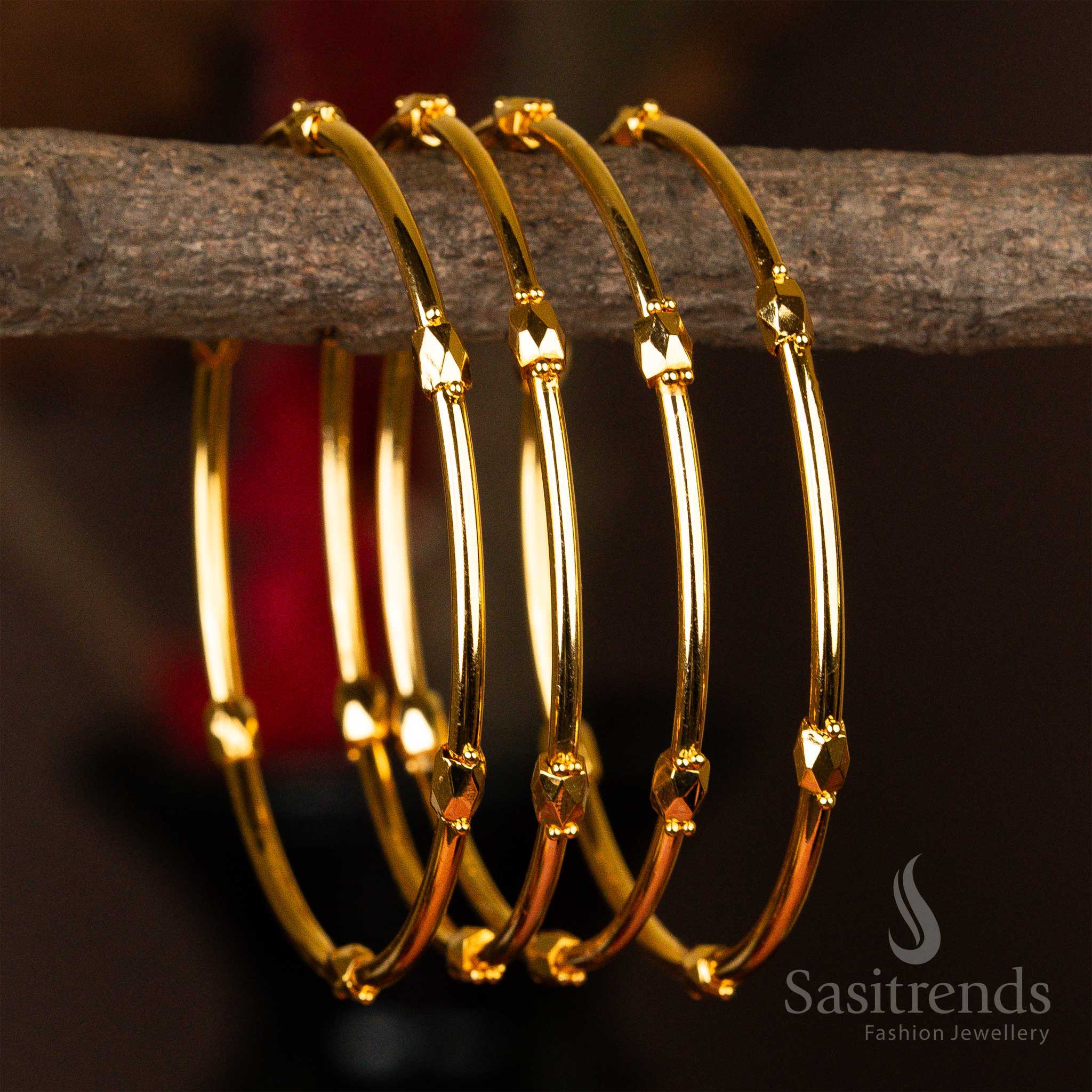 Set of four micro gold-plated kada bangles with elegant faceted golden beads