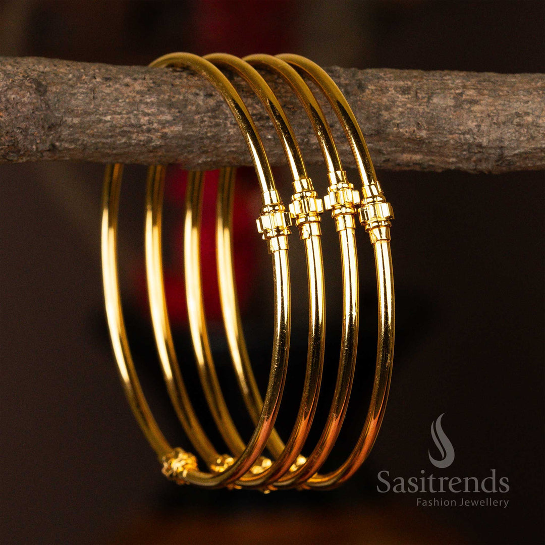 Set of four elegantly micro gold-plated kada bangles with symmetric golden bead accents