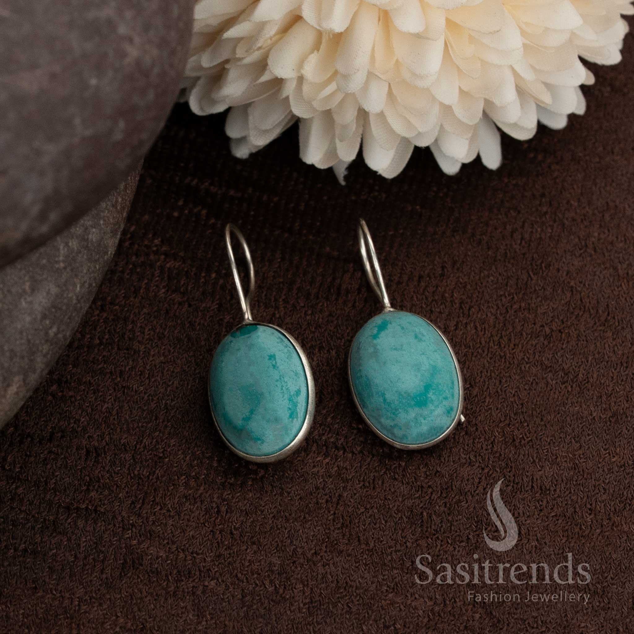 Oxidised round earrings with soothing ocean-blue natural stones inside a polished finish frame best for daily chic and smart wear styles from Sasitrends