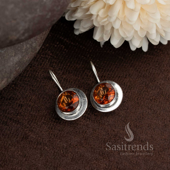 Oxidised round earrings with bright orange stones add colour pop to ethnic or fusion outfits from Sasitrends