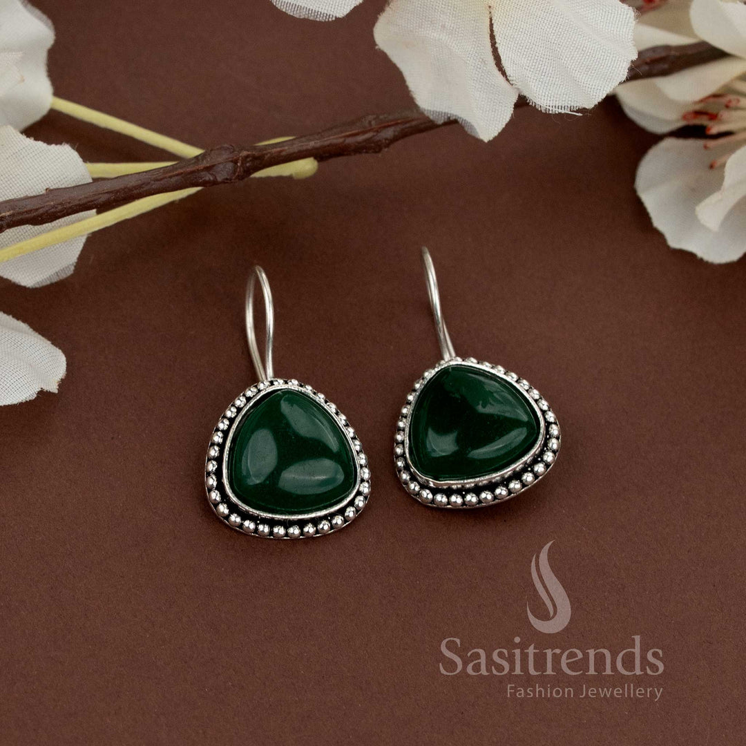 Elegant oxidised earrings with green natural stone and a beaded edge suitable for ethnic outfits and occasional gatherings from Sasitrends