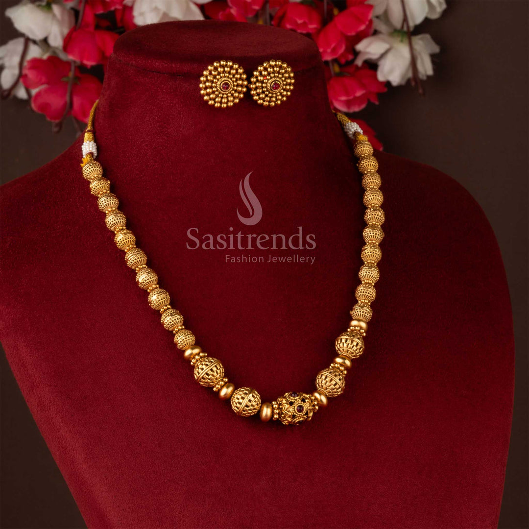 Traditional gold-plated beaded brass necklace and earrings on burgundy display - Sasitrends