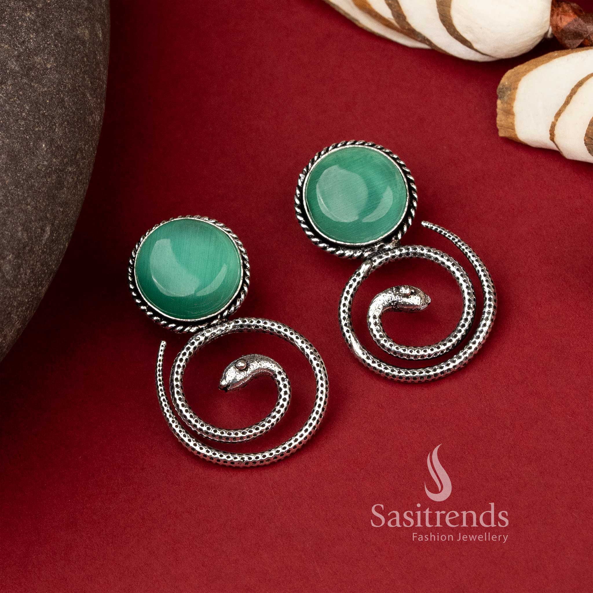 Coiled snake earrings featuring emerald Mint Monalisa stone