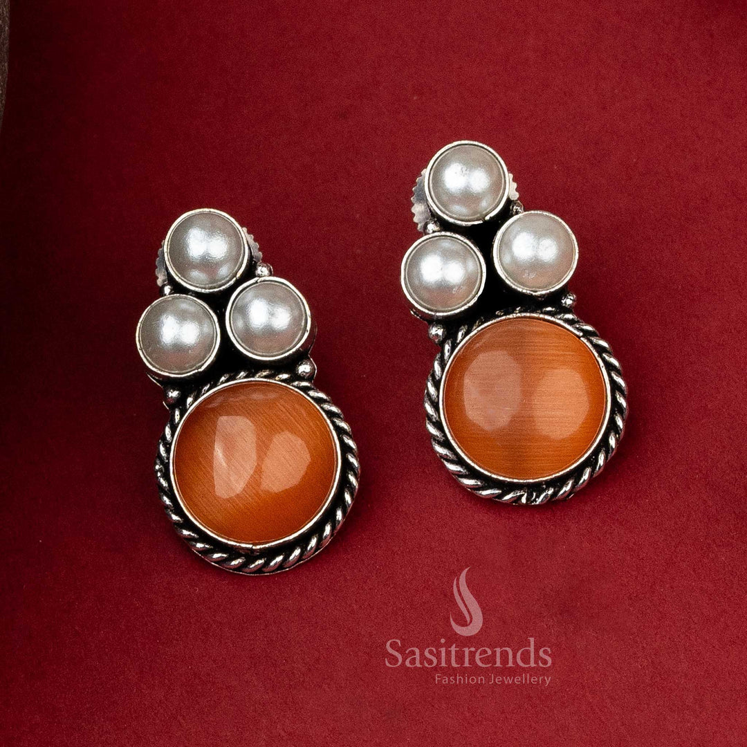 Oxidised silver earrings with a triangular pearl pattern and a warm peach Monalisa stone for a subtle charm.
