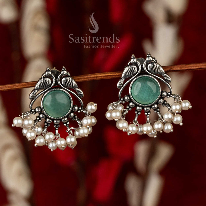 Mint Monalis stone set in ornate oxidised peacock earrings with pearl details