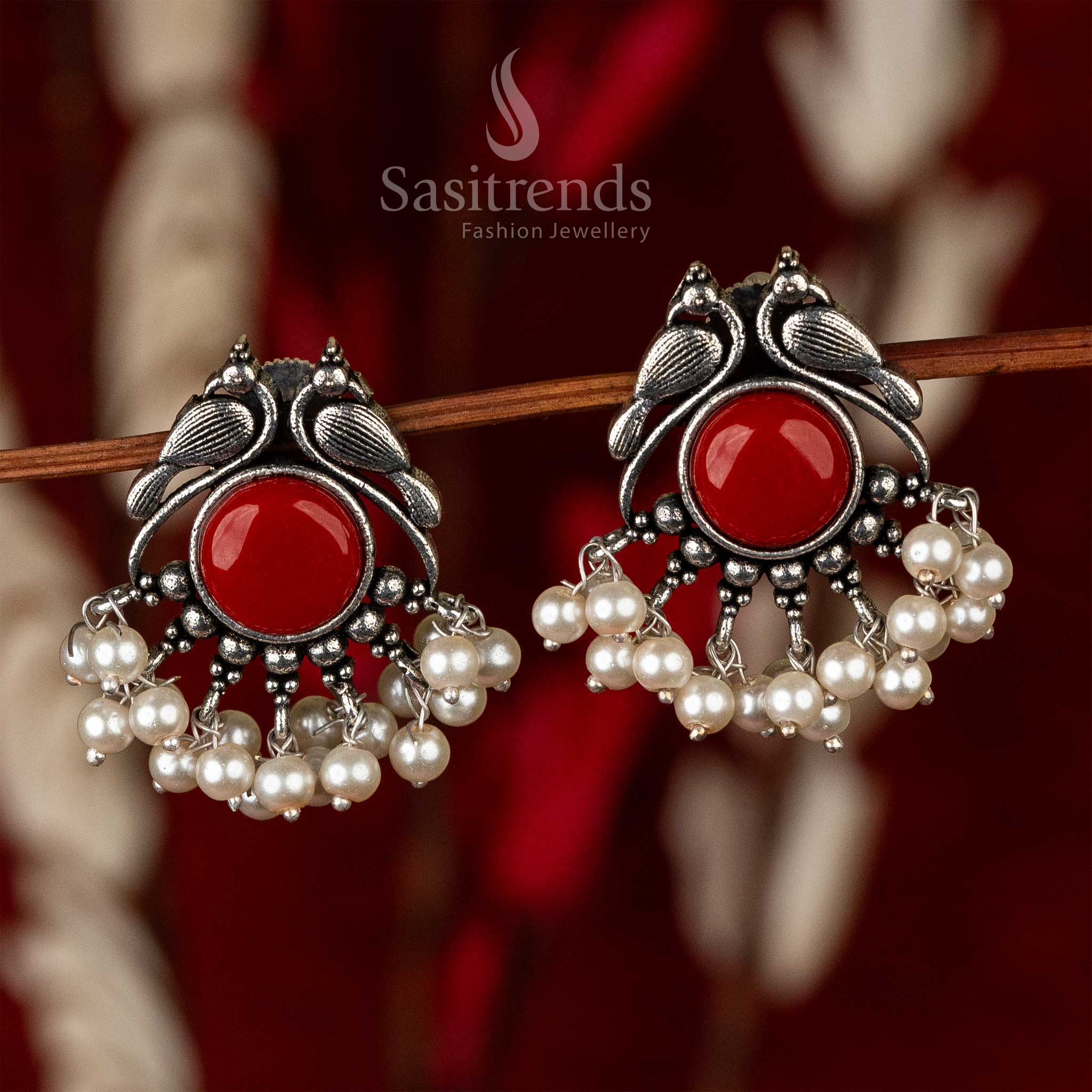 Oxidised peacock earrings with a radiant crimson stone and a fringe of pearls