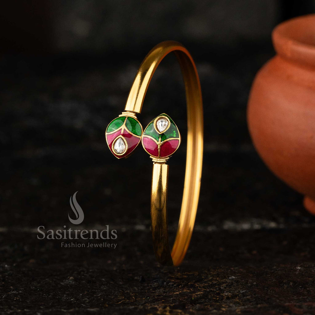 Matte Gold Kada Bangle with vibrant green and red enamel detailing in a traditional Kundan setting.