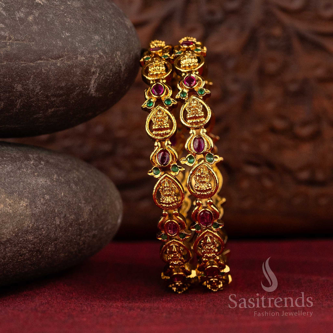 Matte gold bangles with Lakshmi motifs and colored gemstone accents, adding a touch of brilliance and tradition to your attire - Sasitrends