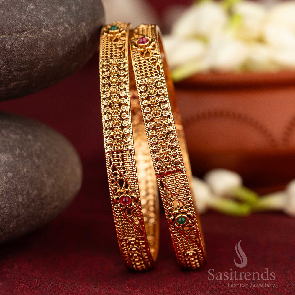 Antique matte gold plated bangles with ruby-green Kemp stones and ornate floral and geometric motifs, reflecting devotional splendour and traditional South Indian jewellery elegance from Sasitrends