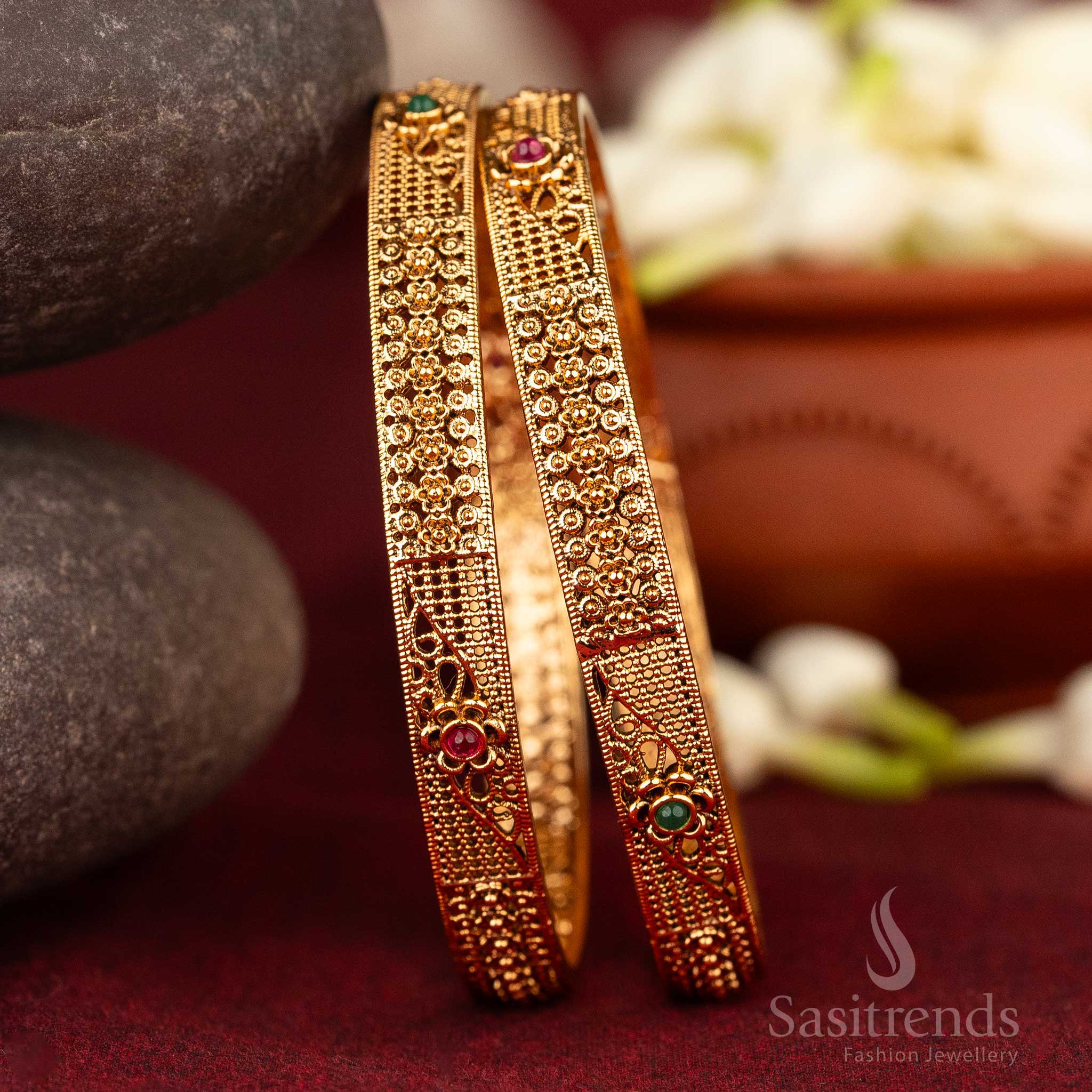Antique matte gold plated bangles with ruby-green Kemp stones and ornate floral and geometric motifs, reflecting devotional splendour and traditional South Indian jewellery elegance from Sasitrends