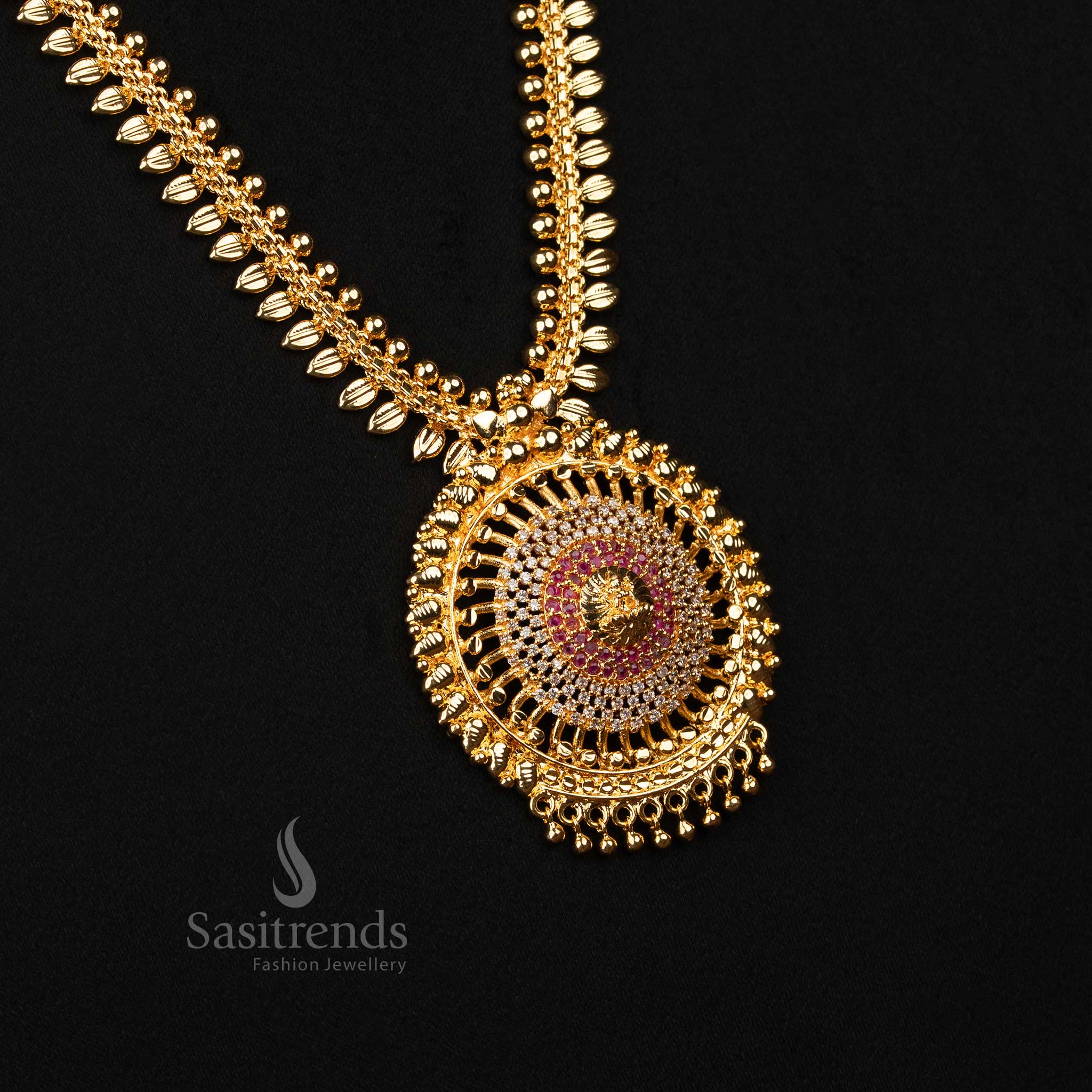 Divine white-ruby micro gold-plated long haram necklace with Lakshmi pendant, delicate leaf detailing and shimmering American Diamond stones – A glorious temple jewellery piece for bridal or festive elegance – Sasitrends