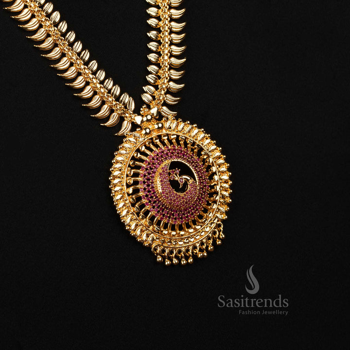 Vibrant ruby tone long necklace with majestic peacock motif and flowing leaf detailing in temple design – Embellished with AD stones and one gram gold finish – Sasitrends