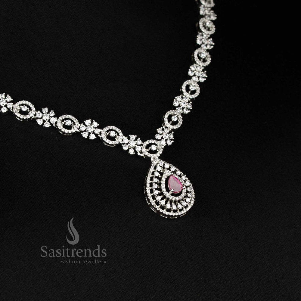 Close-up of dazzling American Diamond rhodium plated teardrop drop earrings with central accent stone - Sasitrends