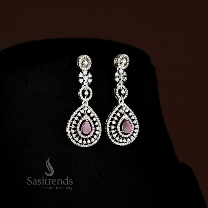 Close-up of dazzling American Diamond rhodium plated teardrop drop earrings with central accent stone - Sasitrends