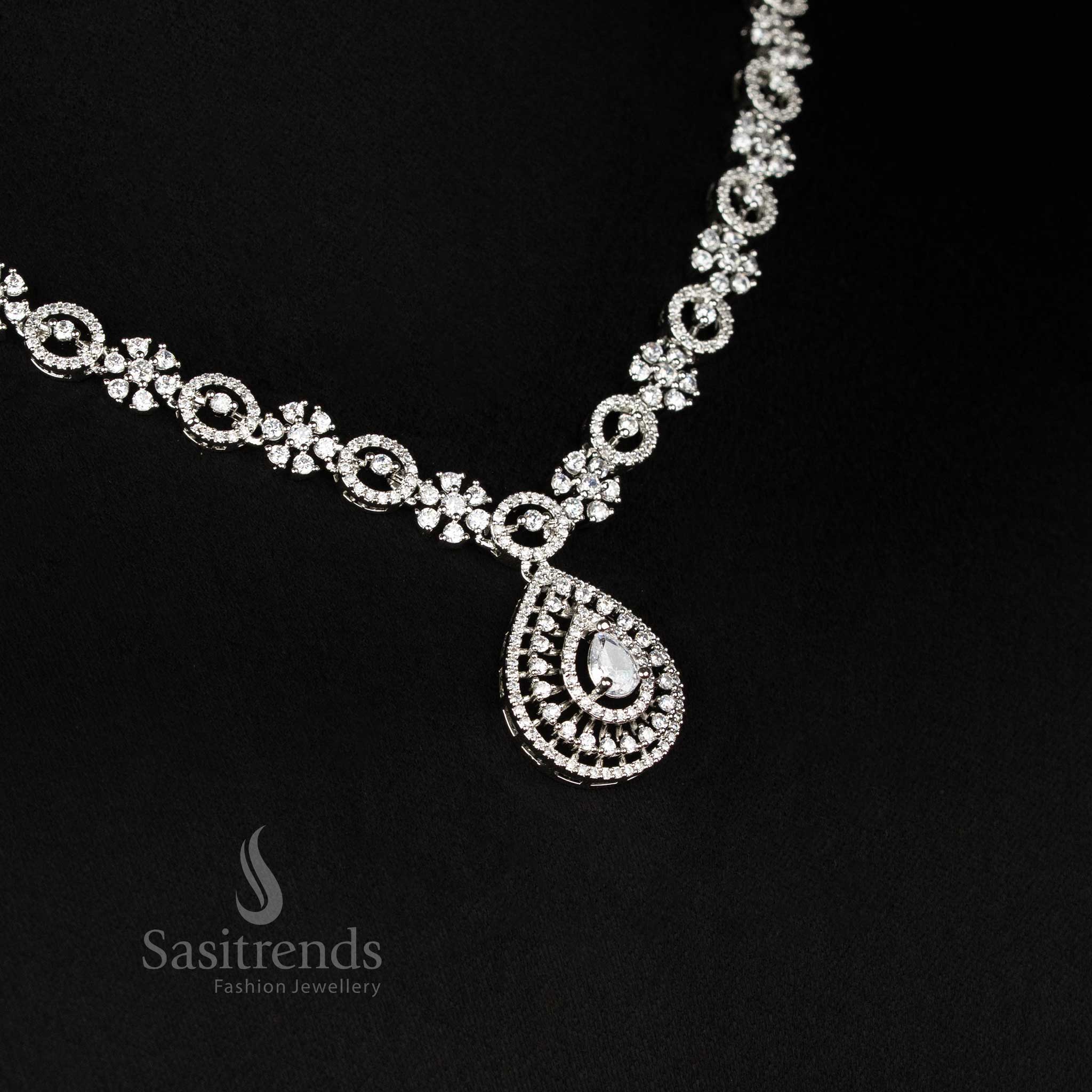 Detailed view of sparkling American Diamond rhodium plated necklace with intricate linked design and teardrop pendant - Sasitrends