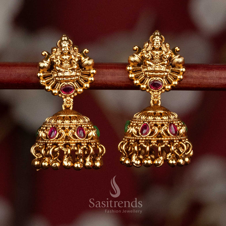 Premium matte gold plated ruby green temple dual peacock Goddess Lakshmi jhumka earrings with screw type back for ceremonial and festive wear-sasitrends